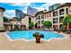 Resort-style pool area with lounge chairs, lush landscaping, and views of the surrounding buildings at 955 Juniper Ne St # 2322, Atlanta, GA 30309