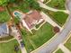 Aerial view of home featuring a large front lawn, mature trees, and an inviting backyard pool at 4235 Night Sky Ln, Cumming, GA 30041