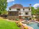 Beautiful backyard with lush landscaping, swimming pool, spa, and manicured lawn at 4235 Night Sky Ln, Cumming, GA 30041