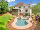 Aerial view of a stunning backyard featuring a pool, spa, patio, and landscaped garden at 4235 Night Sky Ln, Cumming, GA 30041
