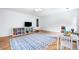 Bright bonus room featuring hardwood floors and a large rug, perfect for to play in at 4235 Night Sky Ln, Cumming, GA 30041