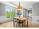 Light-filled dining room with a wooden table, stylish chairs, and large windows offering verdant views at 4235 Night Sky Ln, Cumming, GA 30041