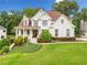 Charming two-story brick home with a landscaped front yard and a welcoming front porch at 4235 Night Sky Ln, Cumming, GA 30041