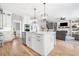 Spacious kitchen with a center island, modern appliances, and an open layout to the living area at 4235 Night Sky Ln, Cumming, GA 30041