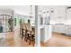 Bright open kitchen with a center island, white cabinets, stainless steel appliances, and hardwood floors at 4235 Night Sky Ln, Cumming, GA 30041