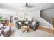 Open concept living room with hardwood floors, a comfortable sectional sofa, and a view into the modern kitchen at 4235 Night Sky Ln, Cumming, GA 30041