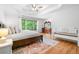 Airy main bedroom featuring a trey ceiling, hardwood floors, and large windows offering plenty of natural light at 4235 Night Sky Ln, Cumming, GA 30041