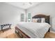 Comfortable bedroom featuring a large bed, wood floors, and large windows providing natural light at 4235 Night Sky Ln, Cumming, GA 30041
