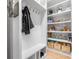 Well-organized mud room with storage shelves, hooks, and a bench for convenience at 4235 Night Sky Ln, Cumming, GA 30041