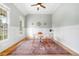 Bright home office with wainscoting, a modern desk, and a stylish rug on hardwood floors at 4235 Night Sky Ln, Cumming, GA 30041