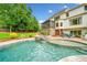 Beautiful backyard pool with a spillover hot tub, complemented by a screened porch and manicured landscaping at 4235 Night Sky Ln, Cumming, GA 30041