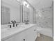 Modern bathroom features double vanity, marble backsplash, a shower and tub combination, and modern fixtures at 4336 Southvale Dr, Decatur, GA 30034