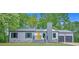 Charming single-story home with a bright yellow door, gray siding, and lush green lawn at 4336 Southvale Dr, Decatur, GA 30034
