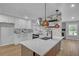 Modern kitchen with white cabinets, sleek countertops, designer backsplash, stainless steel appliances, and large island at 4336 Southvale Dr, Decatur, GA 30034