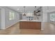 Bright modern kitchen featuring a large island, stainless appliances, and a view into the living room at 4336 Southvale Dr, Decatur, GA 30034