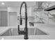 Modern kitchen features a deep sink, marble countertops and backsplash, a stainless steel range, and white cabinets at 4336 Southvale Dr, Decatur, GA 30034