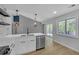 Modern kitchen with stainless steel appliances, quartz countertops, sleek backsplash, and access to the back deck at 4336 Southvale Dr, Decatur, GA 30034