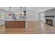Open-concept living room with hardwood floors flows into modern kitchen with island and stainless-steel appliances at 4336 Southvale Dr, Decatur, GA 30034