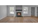 Bright living room featuring a modern fireplace with luxury vinyl plank flooring and large windows at 4336 Southvale Dr, Decatur, GA 30034