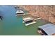 Aerial view of a private boat dock featuring a covered boat lift and a sun deck at 6265 Reives Rd, Cumming, GA 30041