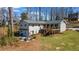 Spacious backyard with a patio area, fire pit, well-maintained lawn, and tasteful landscaping at 6265 Reives Rd, Cumming, GA 30041