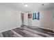 Basement with gray plank floors and a white door to the exterior at 6265 Reives Rd, Cumming, GA 30041