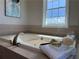 Relaxing bathroom featuring a luxurious bathtub, soft towels, and natural light, creating a spa-like atmosphere for ultimate comfort at 6265 Reives Rd, Cumming, GA 30041