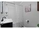 Clean bathroom featuring a shower with a tub and modern black fixtures at 6265 Reives Rd, Cumming, GA 30041