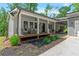 Charming home exterior with a covered front porch, gray siding, manicured landscaping, and inviting curb appeal at 6265 Reives Rd, Cumming, GA 30041