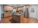 Spacious kitchen with granite countertops, center island, and stainless steel refrigerator at 6265 Reives Rd, Cumming, GA 30041