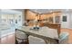 Spacious kitchen with granite countertops, modern appliances, and an adjacent dining area, ideal for Gathering meals and entertaining guests at 6265 Reives Rd, Cumming, GA 30041