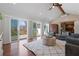 Spacious living room with vaulted ceiling, wood beam, and sliding glass doors leading to an outdoor deck at 6265 Reives Rd, Cumming, GA 30041