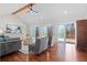 Open-concept living room with hardwood floors, vaulted ceiling, and sliding doors to the outdoor deck at 6265 Reives Rd, Cumming, GA 30041