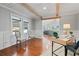Bright office area with hardwood floors and white wainscoting has view to living room at 6265 Reives Rd, Cumming, GA 30041