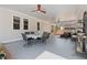 Covered outdoor patio with ceiling fans, outdoor seating, and a dining table set for six at 6265 Reives Rd, Cumming, GA 30041