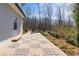 Stone paved patio featuring outdoor seating area and private wooded backdrop at 6265 Reives Rd, Cumming, GA 30041