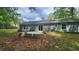 Back exterior view featuring a well-maintained lawn, concrete patio, and sliding glass door at 2849 Appling Way, Kennesaw, GA 30152
