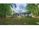 Rear exterior of the home with a lush backyard, a wooden fence, and a charming patio area at 2849 Appling Way, Kennesaw, GA 30152