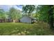 Back exterior, displaying an expansive yard with a wooden fence and lush green lawn at 2849 Appling Way, Kennesaw, GA 30152