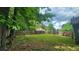 Exterior view of the spacious, grassy backyard with a wooden fence, offering privacy and natural beauty at 2849 Appling Way, Kennesaw, GA 30152