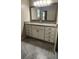 Bathroom featuring large mirror, granite countertop and tiled floor and white cabinets at 2849 Appling Way, Kennesaw, GA 30152
