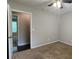Neutral bedroom with carpet flooring and an open door leading to another room at 2849 Appling Way, Kennesaw, GA 30152
