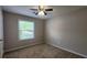 Bedroom featuring carpet flooring, neutral walls, and natural light from the window at 2849 Appling Way, Kennesaw, GA 30152