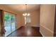 Dining room with wood floors, modern chandelier, and sliding glass doors at 2849 Appling Way, Kennesaw, GA 30152