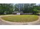 Beautiful home on a corner lot featuring a manicured lawn, mature trees, and a fenced-in yard at 2849 Appling Way, Kennesaw, GA 30152
