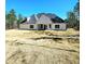 Expansive backyard view featuring a lush green lawn and white single story home at 261 Arborview Dr, Mcdonough, GA 30252