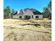 Expansive backyard featuring a well-maintained lawn, a covered patio, and mature trees offering privacy at 261 Arborview Dr, Mcdonough, GA 30252