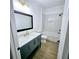 Modern bathroom with blue vanity, quartz countertop, and tiled shower/tub combo at 261 Arborview Dr, Mcdonough, GA 30252