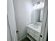 Elegant bathroom features a vanity with a marble countertop, stylish mirror, and modern lighting at 261 Arborview Dr, Mcdonough, GA 30252
