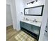 Nicely renovated bathroom with a blue vanity, dual sinks, and modern fixtures at 261 Arborview Dr, Mcdonough, GA 30252